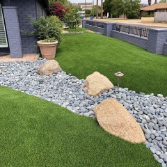 This river of boulders gives this front yard a unique look