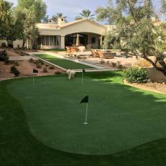 A beautiful putting green and bocce ball court blends seamlessly with xeriscaping